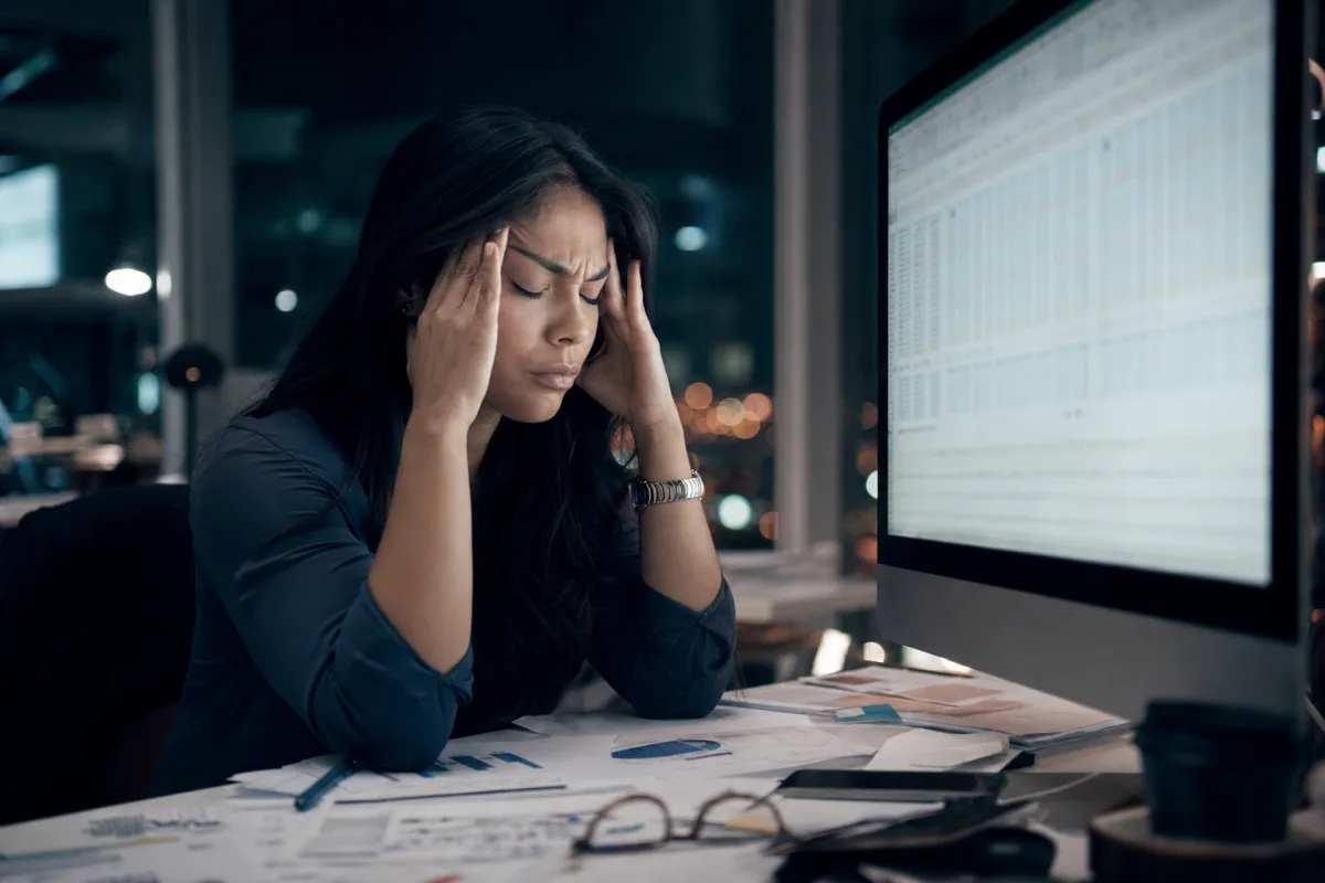 Mujer estresada frente a una planilla de Excel manipulada con datos sospechosos
